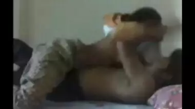 couple on bed grabbing & kissing each other